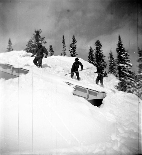 BW Photos showing rangers digging out the visitor center from snowdrift.