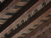 The ceiling of a building is made of wood.