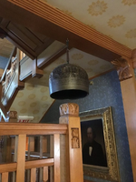 a large round bell that is hanging from the ceiling