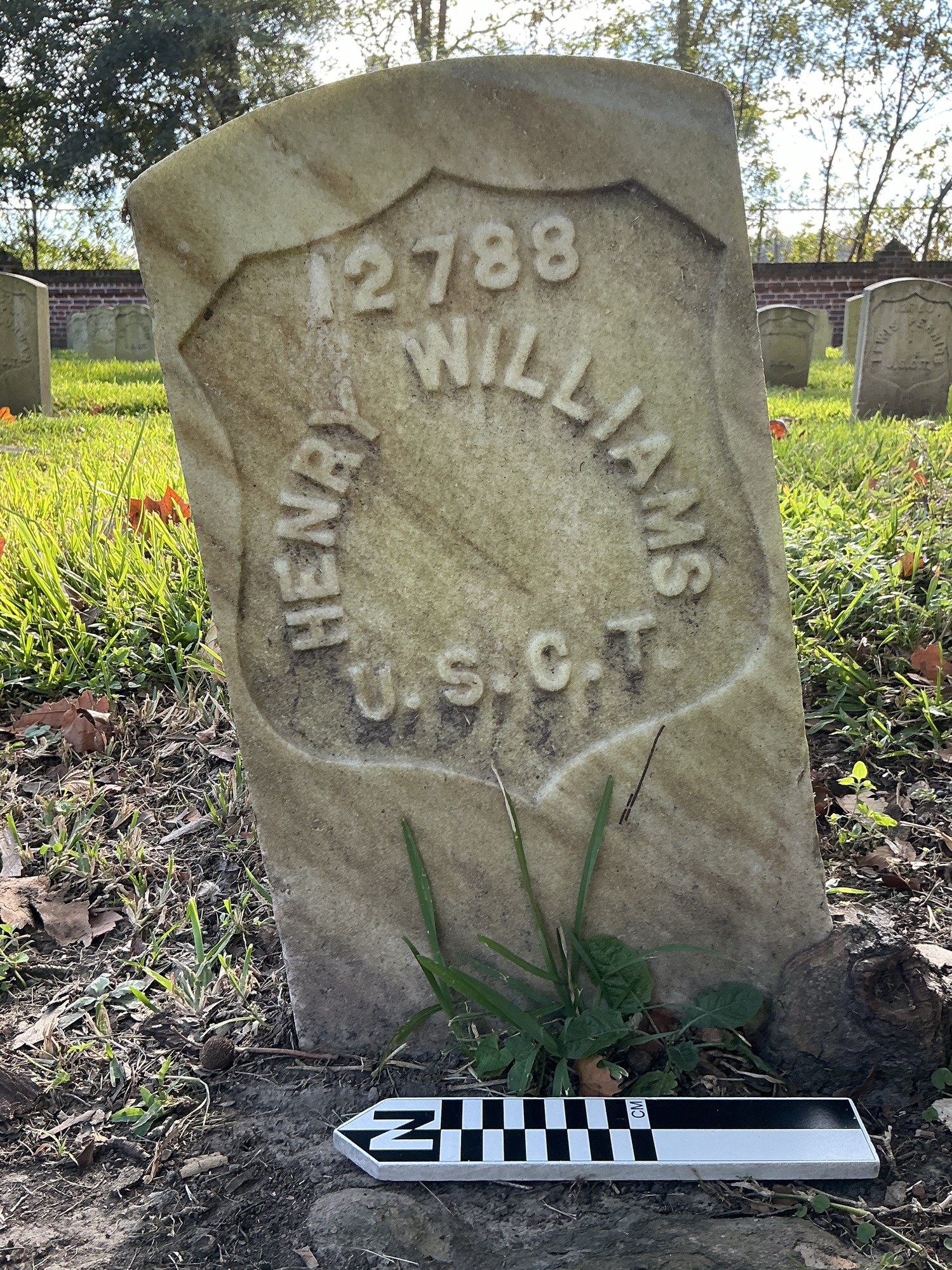 Extra image of historic upright marble headstone with recessed shield face.