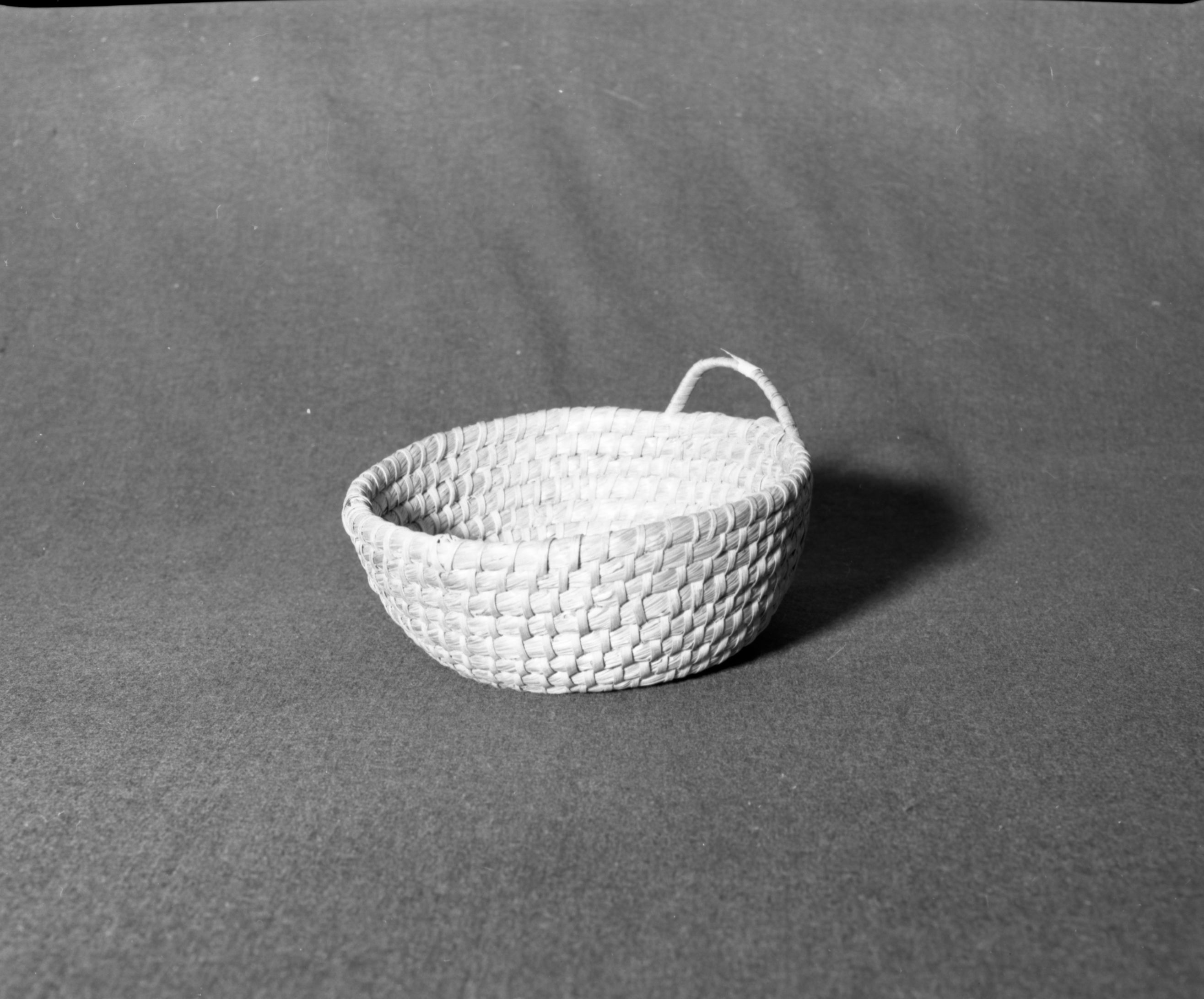Marie Rozier Collection, Catalog No. 190. Object: Coiled basket. Dimensions: 9 x 3 1/2". Materials: unidentified. Technology: apparently grass foundation, leftward coil direction, inside work face, interlocking stitch. Collection History: possibly from southeast U.S. Acquired from Dadie McNeill Edsberg. Photographed by Michael Dixon, December 1982. Catalogued by Craig Bates and Barbara Beroza. Yosemite Collections, National Park Service.