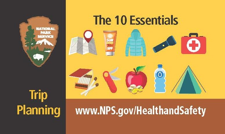 Side 1 of brown and black take away cards on the 10 essentials  – with correlating images of a map, sunscreen, jacket, flashlight, first aid kit, match sticks, pocket knife, an apple, water bottle and a tent 