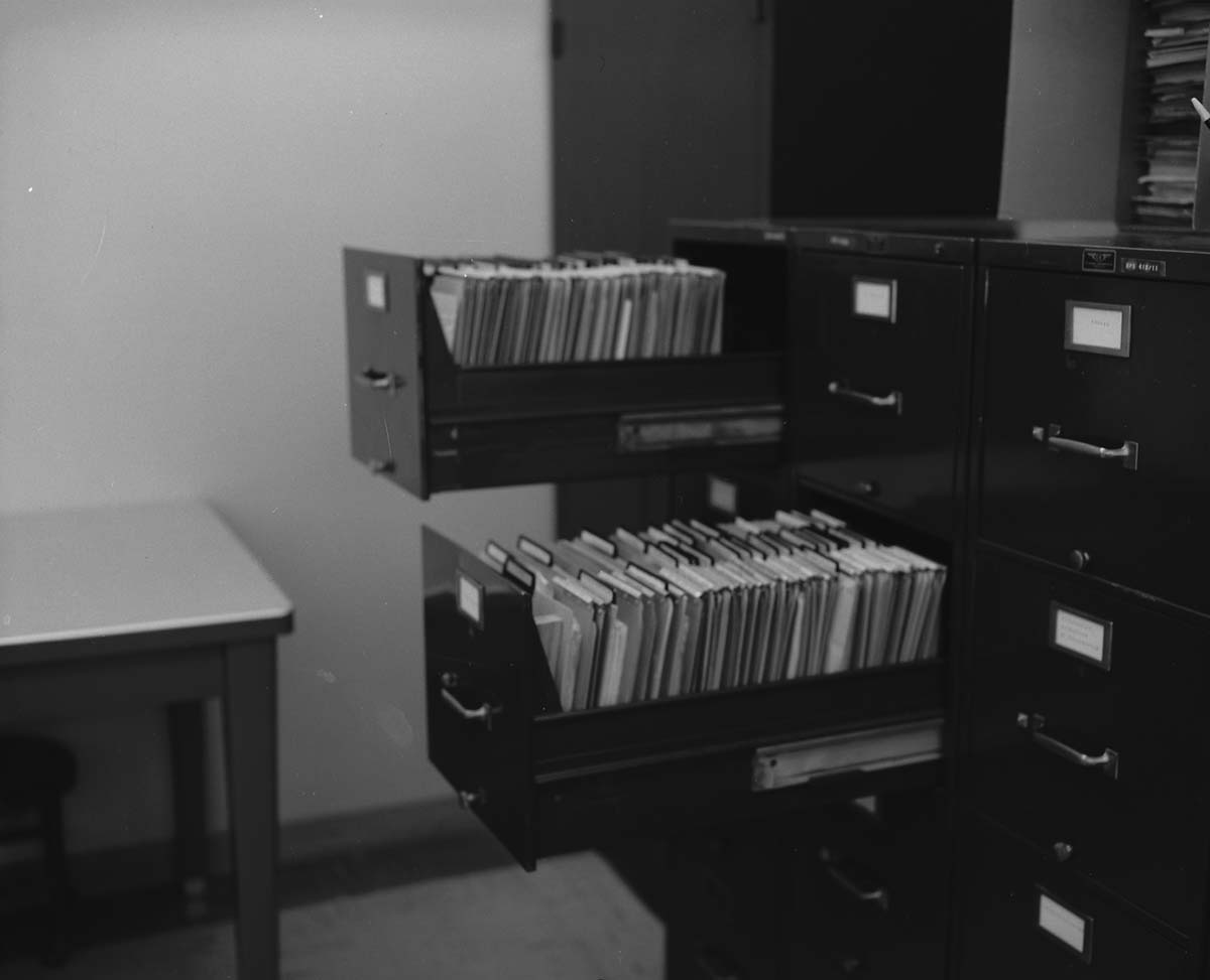 File cabinets improved by use of v-shaped block to hold file divider in place. Block suggested by Z. Brinkenhoff and made by J. Blackburn - for possible incentive award.