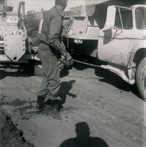 Man working along side construction vehicles during road grading to Chamberlain Ranch and the Narrows.