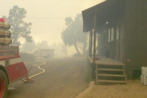 Burning and smoke in and around structures during the Long Mesa Fire, Mesa Verde National Park, July-August 2002