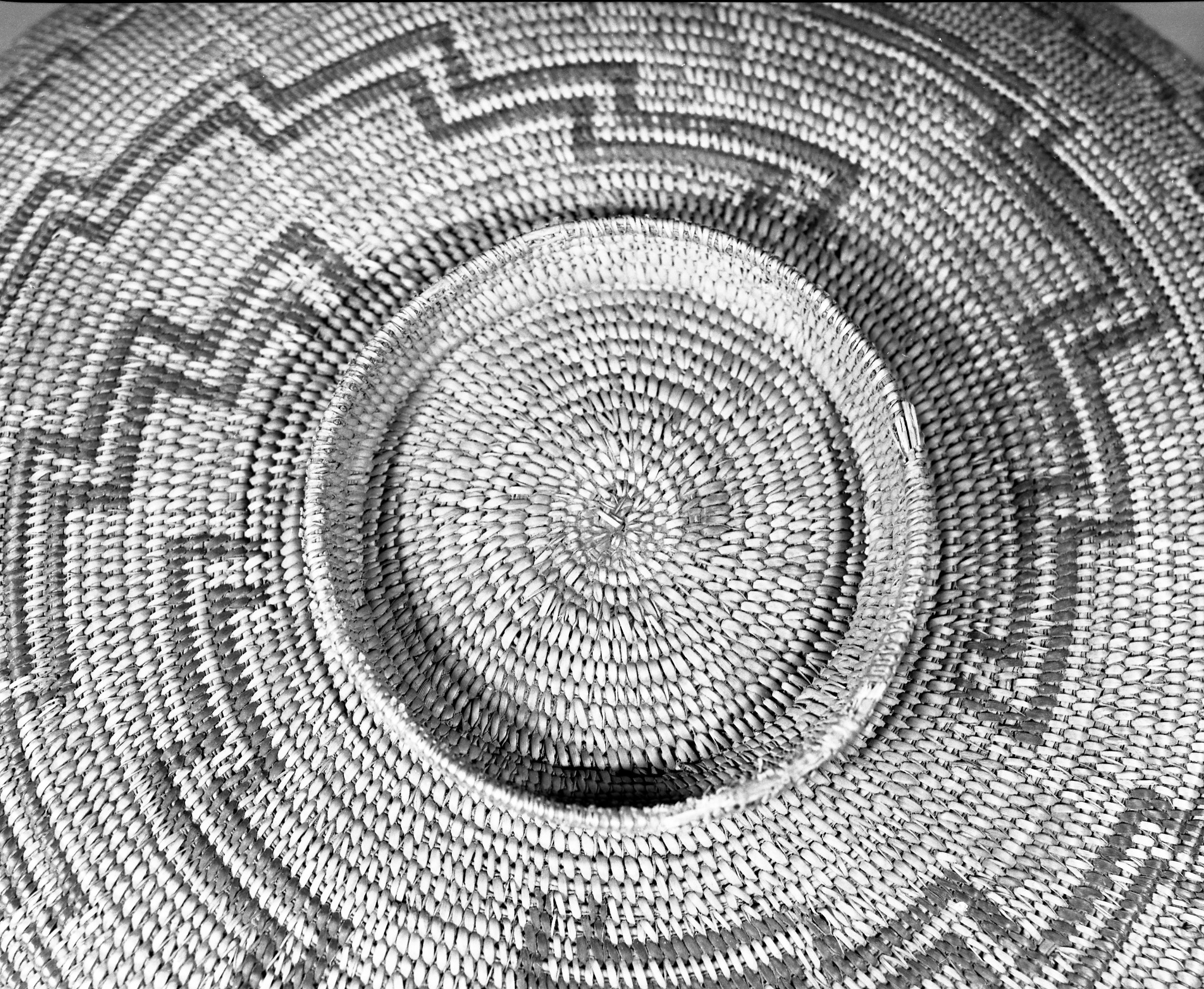 Private Collection. Object: Chumash basket. Dimensions: 16 x 3" (incl. base) Base 3/4" x 5". Materials: Right ward coil direction. Three rod juncus foundation. Technology: Possibly from George Wharton James collection sold by Dawson's Bookstore in Los Angeles, or from a private collection in Newhall. Photographed by Michael Dixon. Catalogued by Craig Bates and Barbara Beroza. Yosemite Collections, National Park Service.