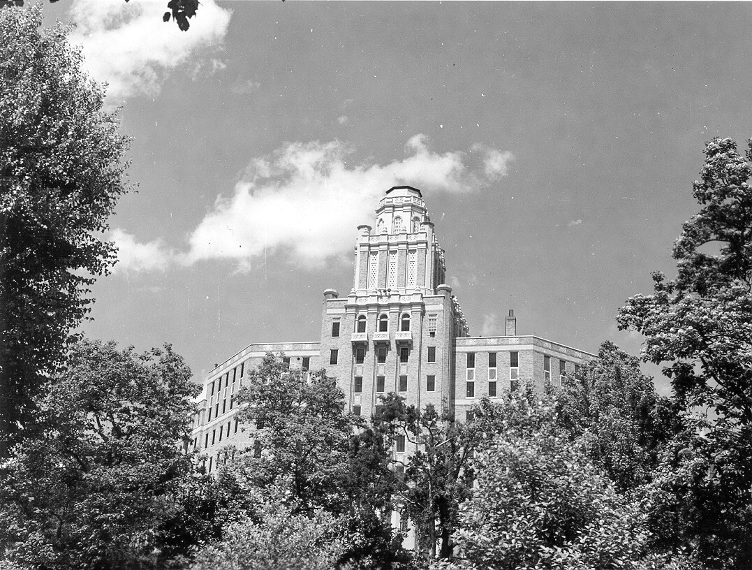 Black & white negative (safety, acetate), 1 print, photo record card; Army-Navy Hospital; Reserve Ave., trees wrap around the outer edge of the picture starting in the upper left hand side and going along bottom and up around ending past the upper right hand corner, some of the lower parts of the building are not visible behind the trees.