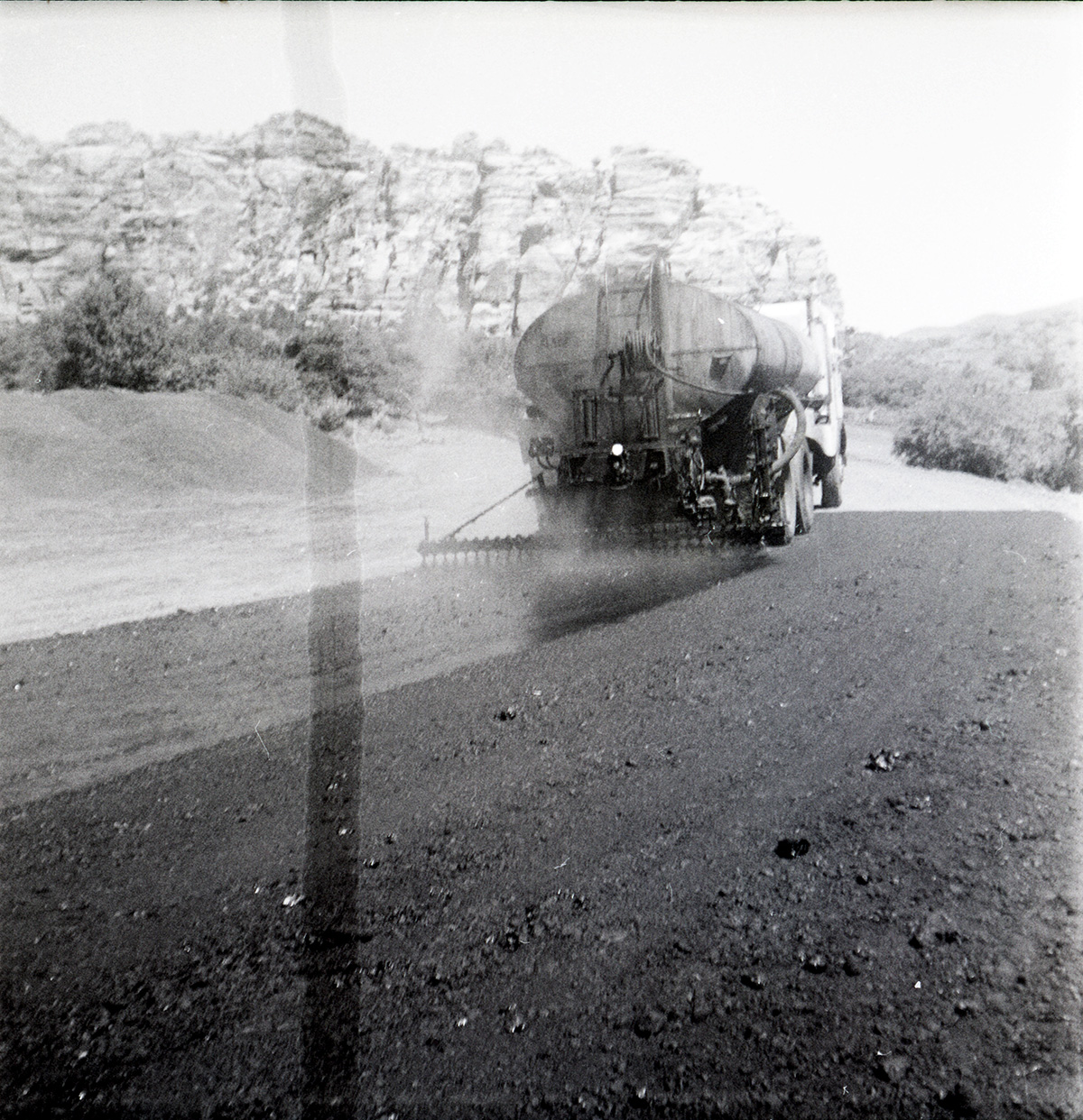 View from behind of construction vehicle during chipsealing of Kolob Canyon Road.