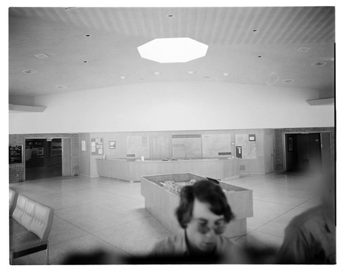 Visitors viewing the interpretive display in the old Mission 66 Visitor Center and Museum.