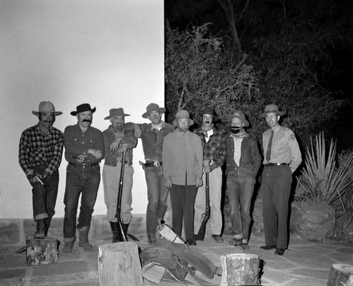 Staff in pioneer costumes and ranger in uniform posing on stage during campfire program. Campfire Day, September 19, 1957 at the South Campground amphitheater.