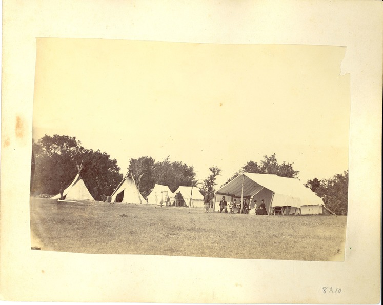 Group [Left to Right]: Unidentified 7th Cavalry Trooper, Lieutenant George Armstrong Custer, Dr. Dunbar, Elizabeth Bacon Custer, Lieutenant Thomas Ward Custer, Nettie Smith, Mary McIntosh, in Front of the Headquarters Tent at the 7th Cavalry Camp Near Fort