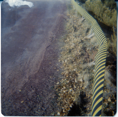 Hazard construction signs showing areas of road that need repair during maintenance.