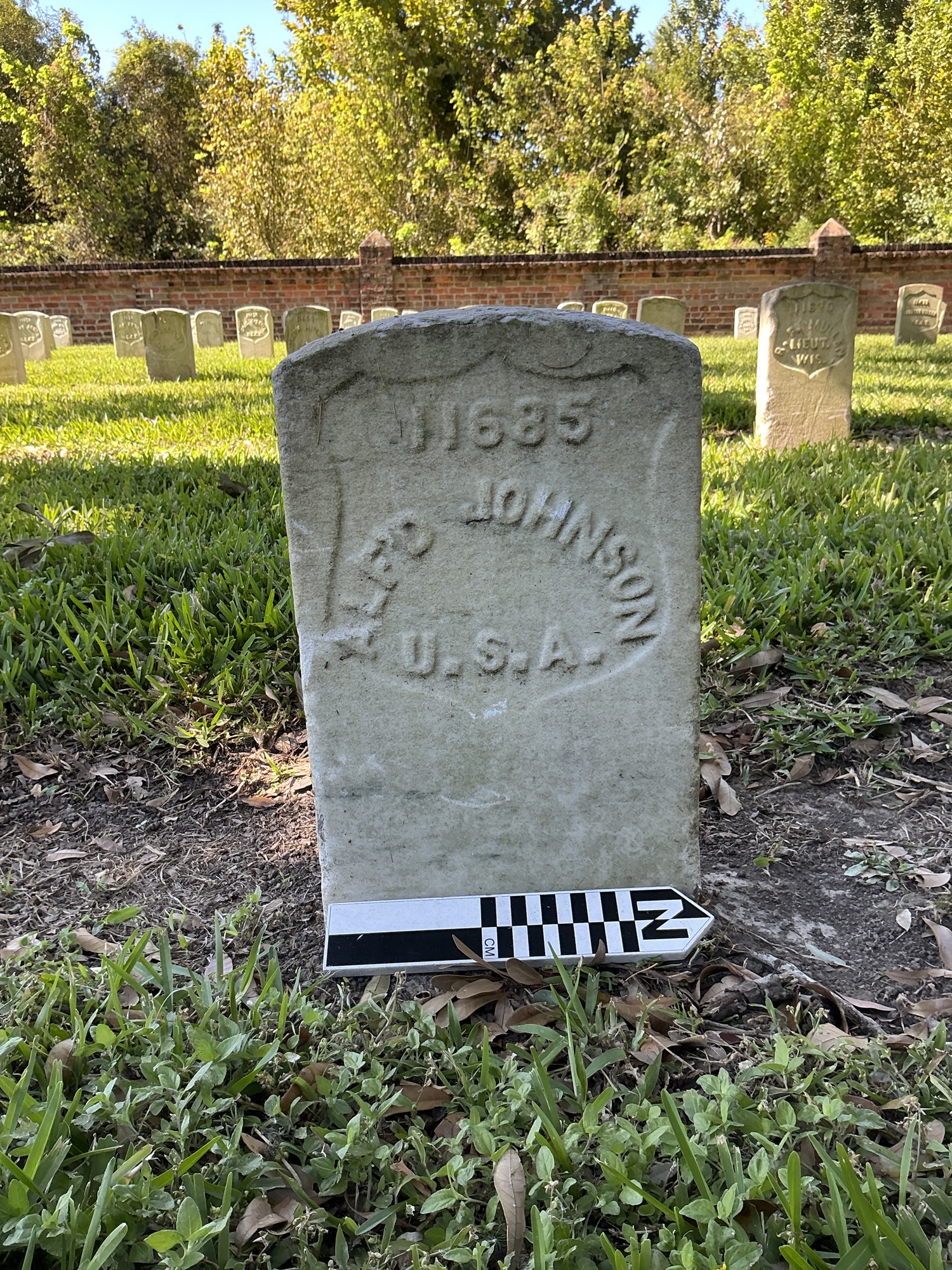 Extra image of historic upright marble headstone with recessed shield face.