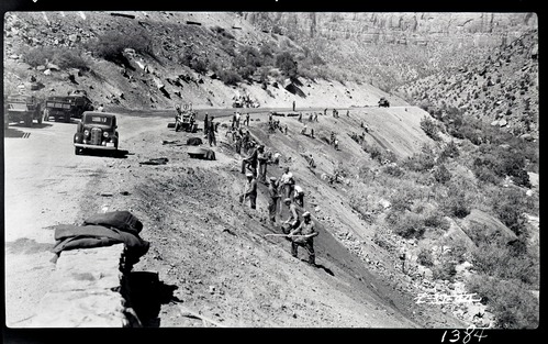 Civilian Conservation Corps (CCC) workers engaged in 'bank sloping' (hillside stabilization} along the Zion-Mt. Carmel highway below the tunnel.