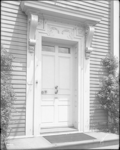 Black and white photograph of ornate front door.