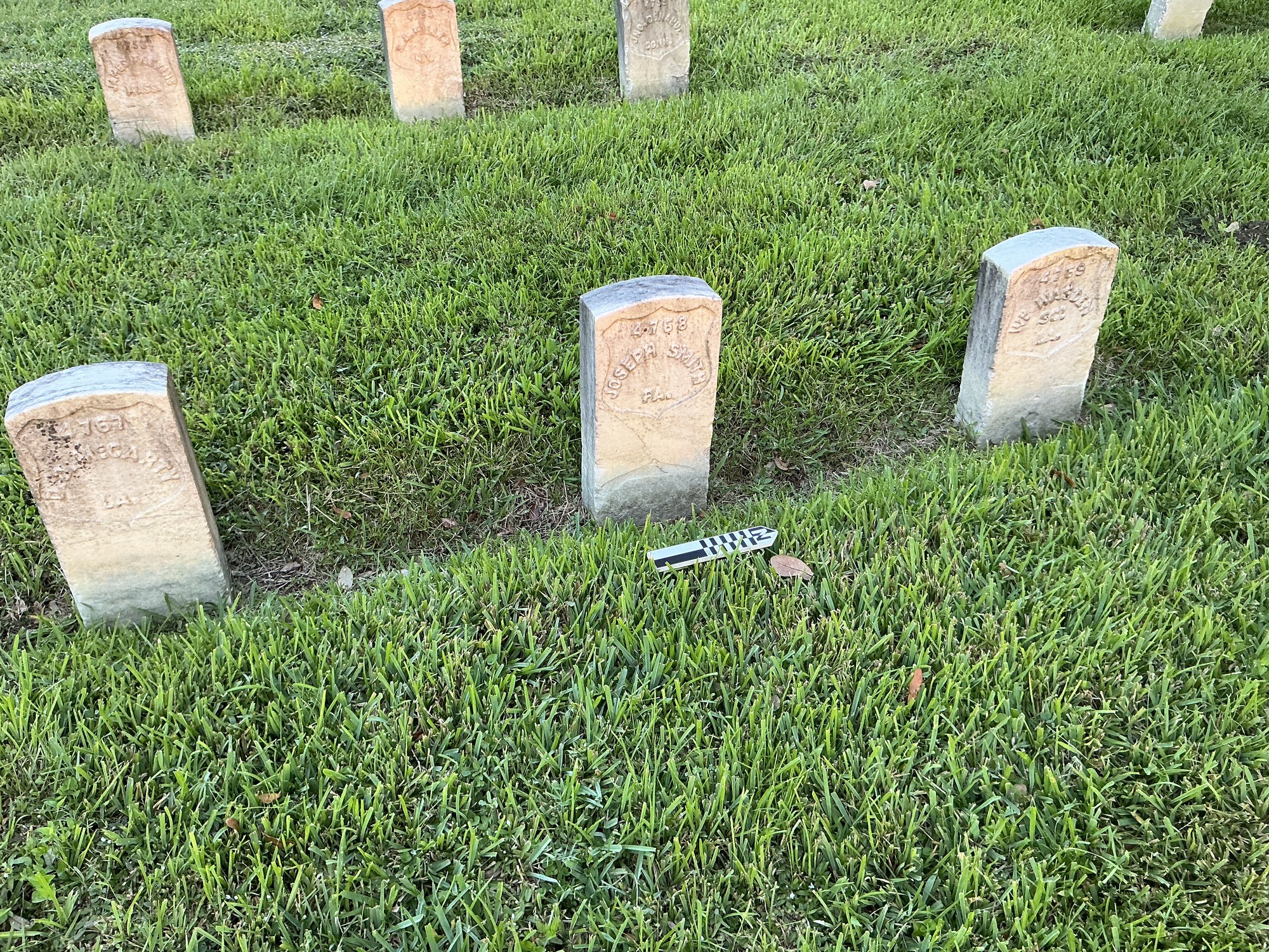 Extra image of historic upright marble headstone with recessed shield face.