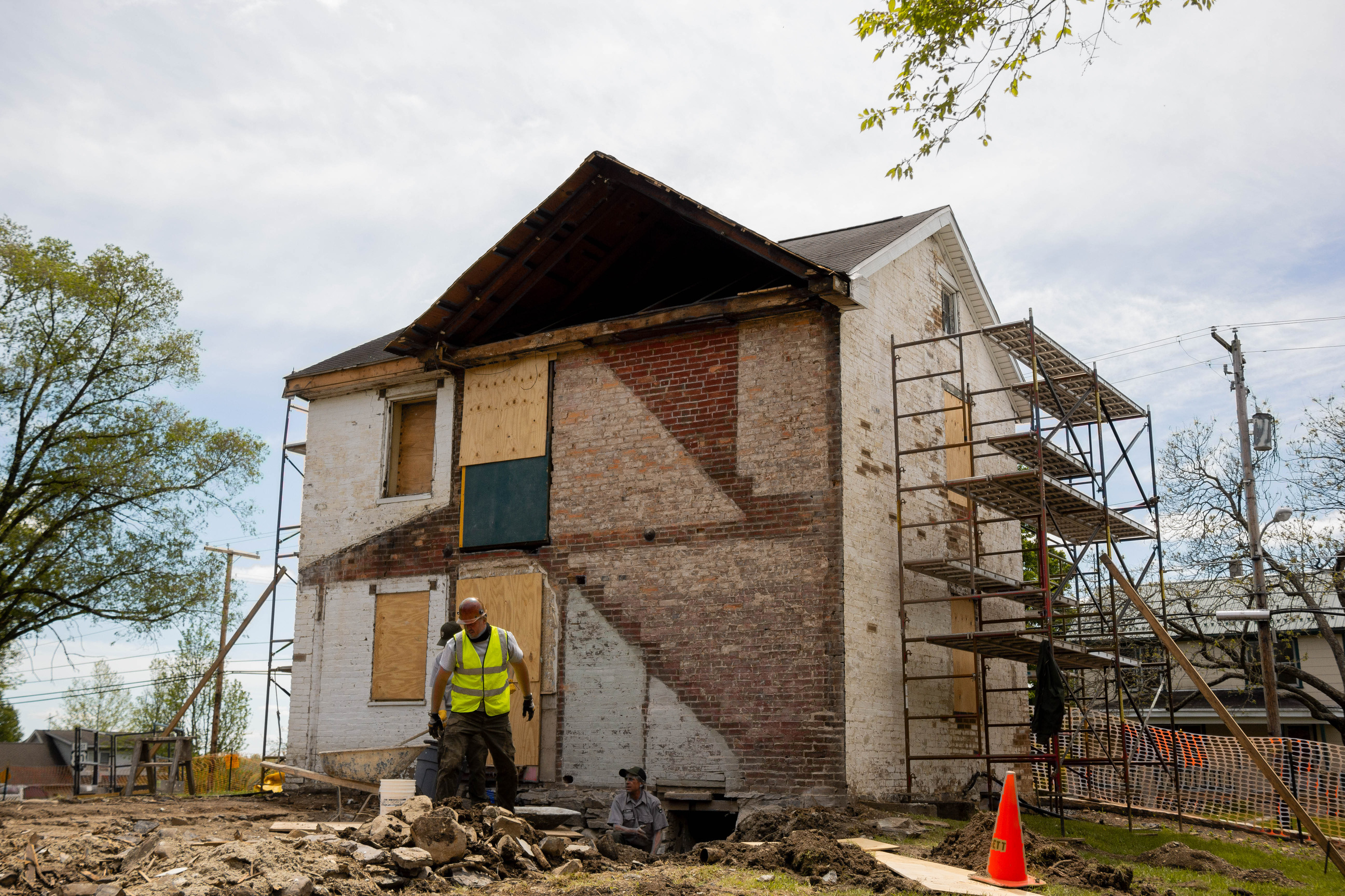 NPS masons select stone to use for the basement wall infill that will match surrounding intact stonework. 