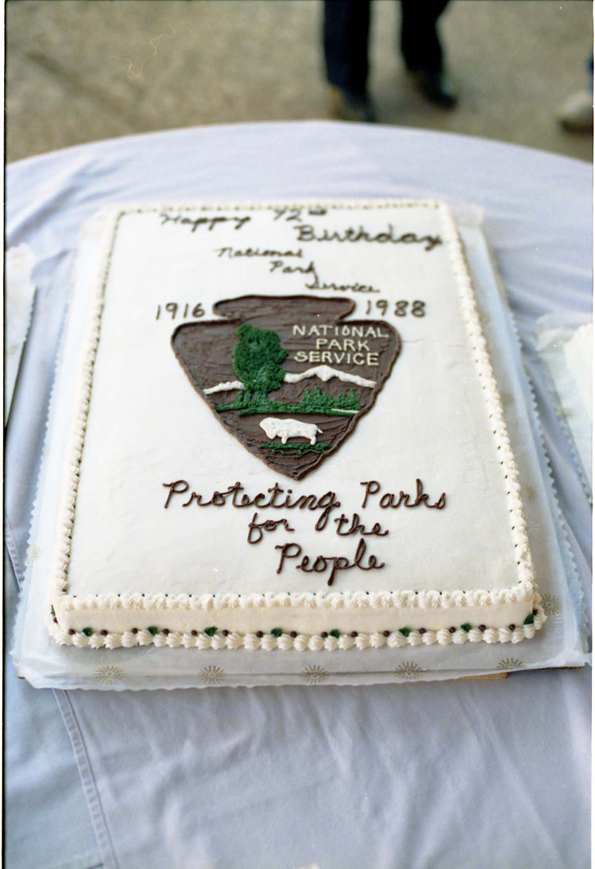 Color Photos of the parks 72nd anniversary celebrations- cake cutting, barbecue, speakers.
