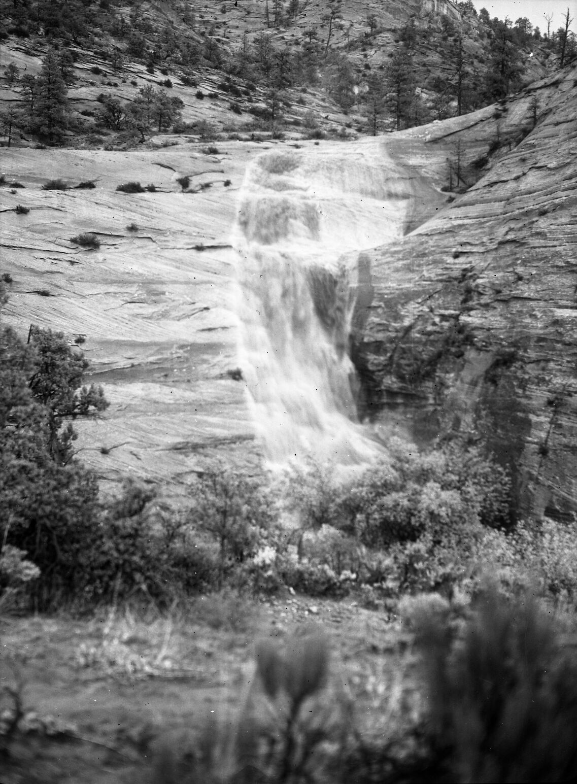 Water cascading off slickrock after storm about 2 miles above short tunnel.