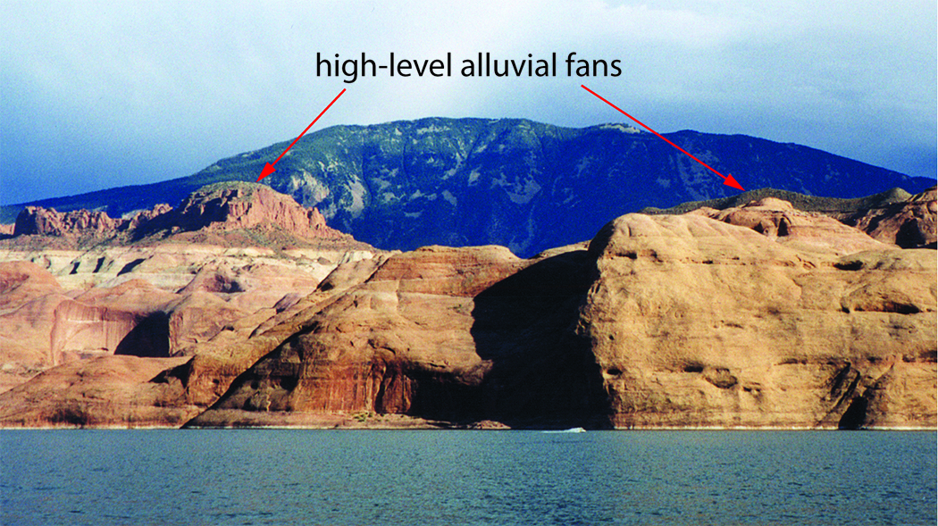 Photograph of Navajo Mountain looming over tall cliffs above Lake Powell. 