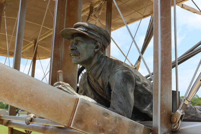 Life-sized statue of Orville Wright on the 1903 Flyer.