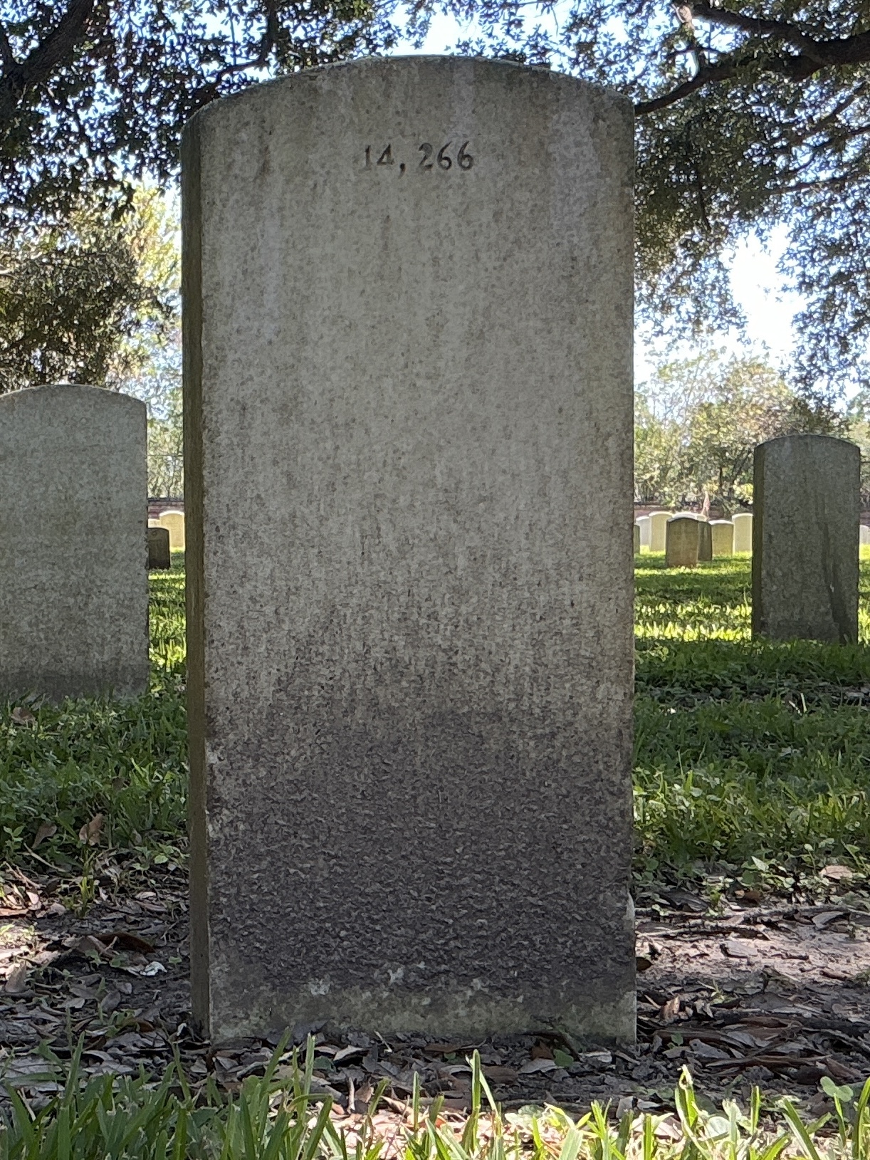 Back of upright marble headstone with flat face.