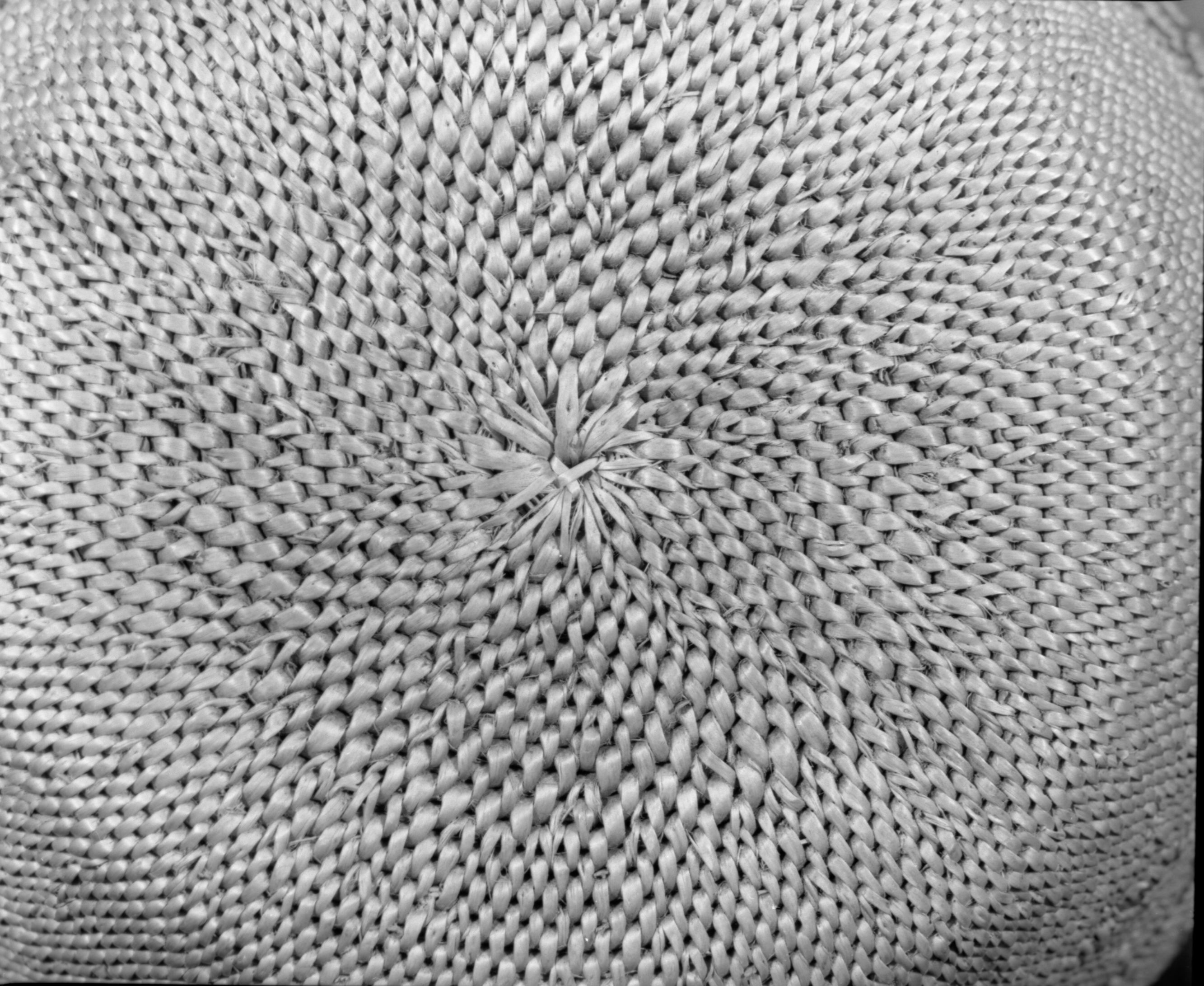 Private Collection. Object: Miwok basket. Dimensions: 12 x 3-3/4". Materials: Redbud, bracken fern, & bull pine. Technology: Single rod, fag ends trimmed on work face, moving ends trimmed on interior. Leftward coil direction. Rim overstitched three times through top rod with two back stitches at coil ending. Overstitched large clockspring start. Triangular design unit group in redbud, linear design units in bracken fern root. Collection History: Made by Matilda, 1920s. Photographed by Michael Dixon. Catalogued by Craig Bates and Barbara Beroza. Yosemite Collections, National Park Service.