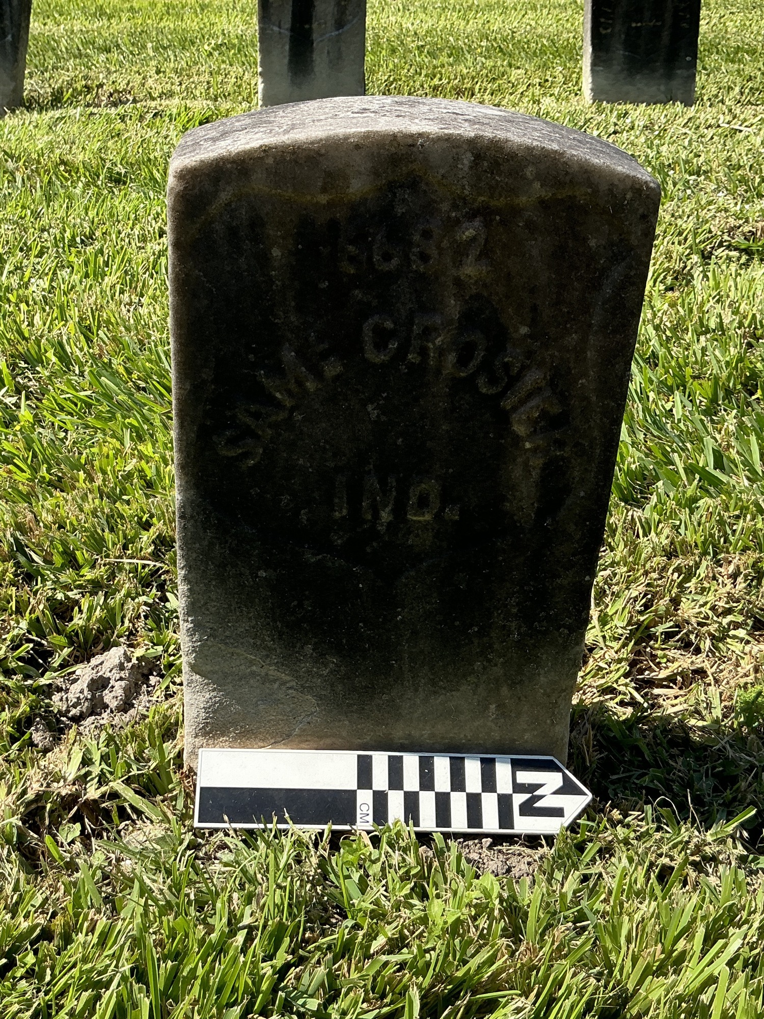 Extra image of historic upright marble headstone with recessed shield face.