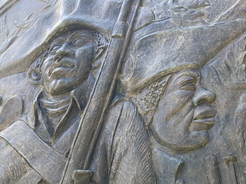 closeup, detail, bronze sculpture, faces, hats, musket