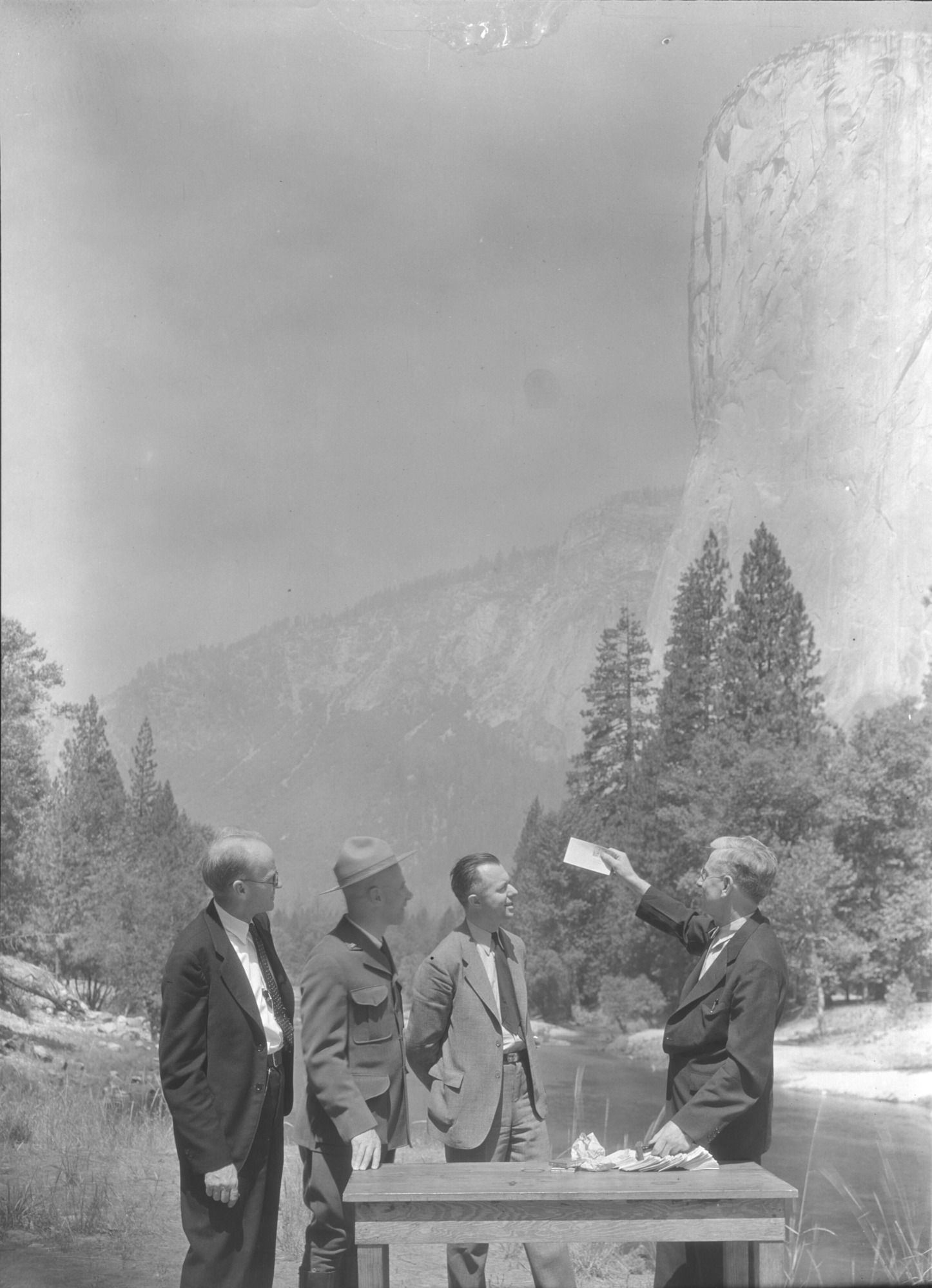 First cover stamp at El Capitan View. "From the Yosemite News Bureau". Yosemite, July 16, 1934. The first 3 letters bearing 1 cent stamps depicting El Capitan, Yosemite. First of the new National Park Series, cancelled July 16, at 9 A.M. in Yosemite National Park, went to Pres. Franklin D. Roosevelt, Sec. Ickes & Postmaster Gen. Farley. The official cancellation ceremony was held at the base of El Capitan. Left to right: C. F. Alexander, Yosemite postmaster; J. W. Emmert, Asst. Supt. of Yosemite; Robert E. Fellers, Supt. Division of Stamps from Washington, who came to supervise the issue; and C. F. Anderson, Post office Dept., Washington, D. C."