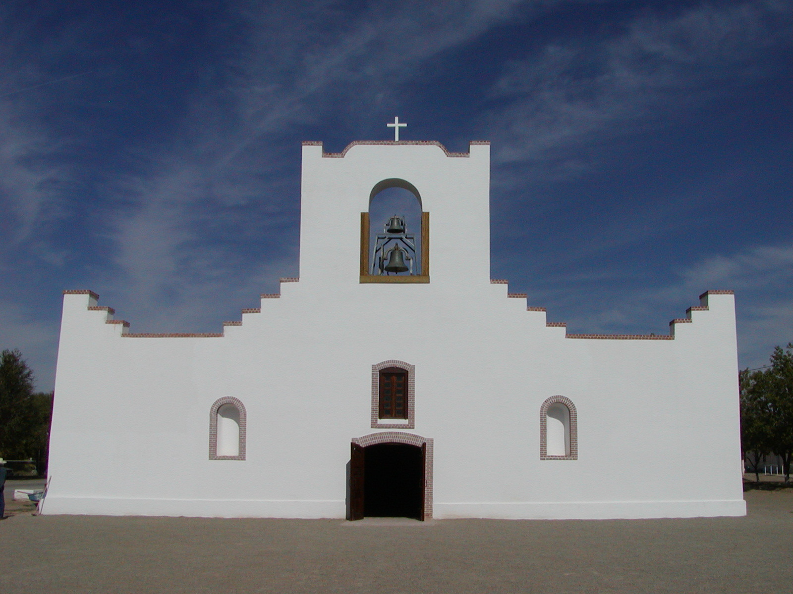 A white building close to a road.