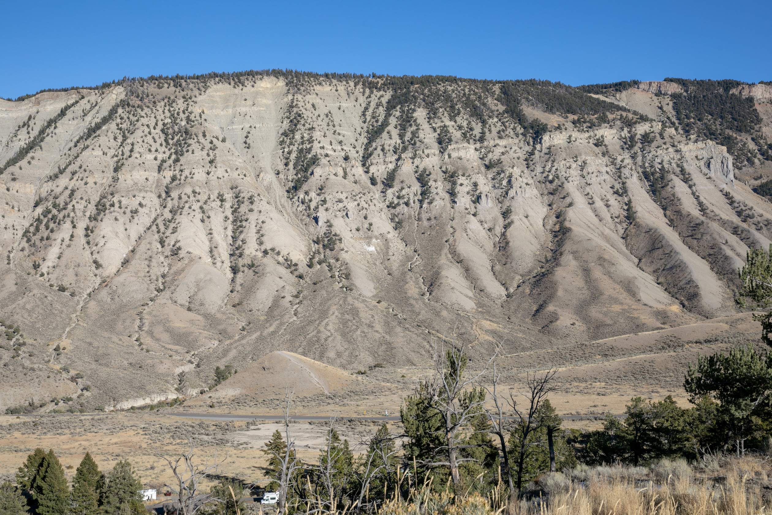 Looking at a flat topped mountain with horizontal layers of rock exposed