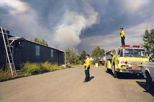 Firefighters provide structural protection to commercial buildings during the Bircher fire, Mesa Verde National Park, July 2000