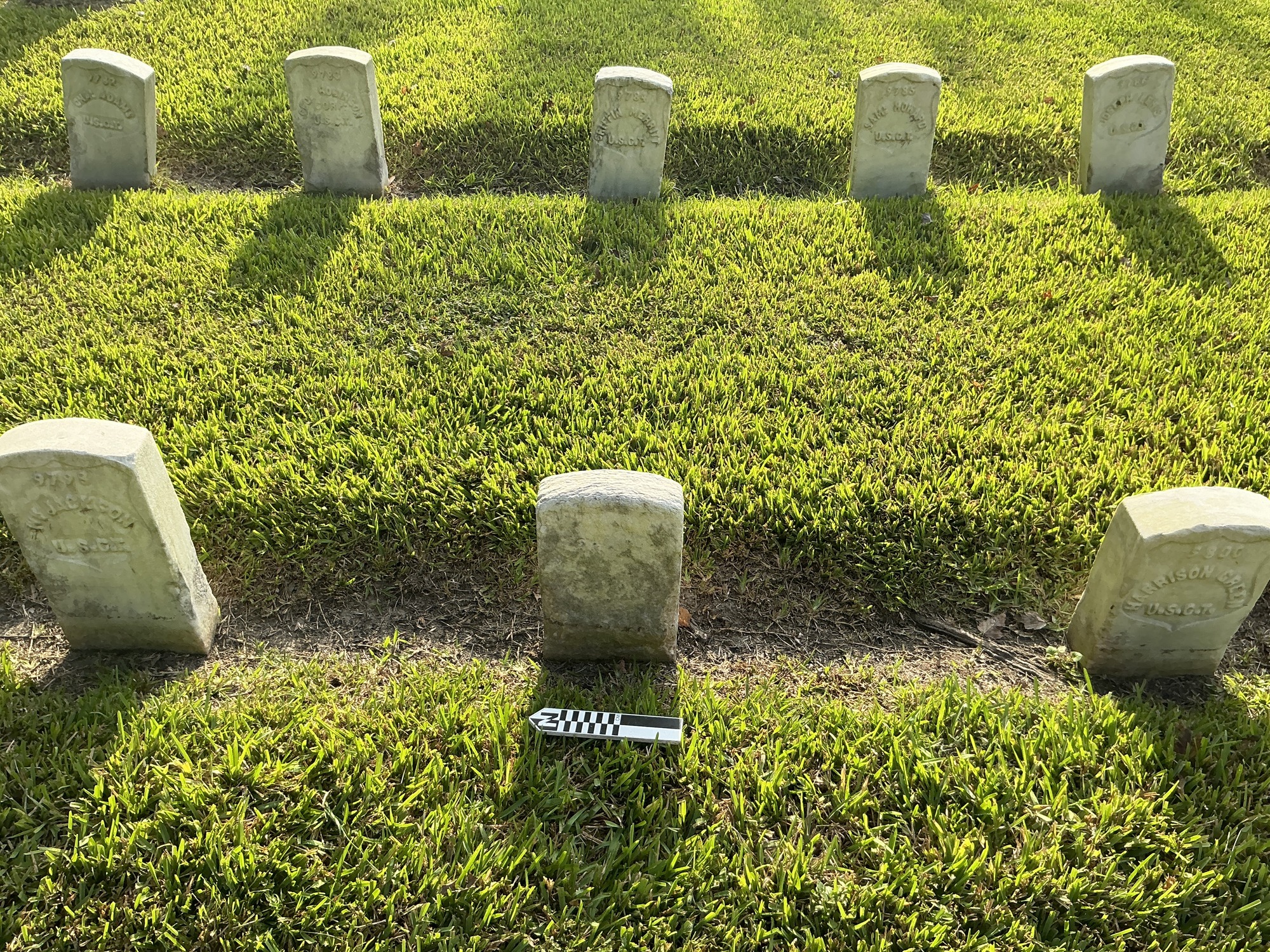 Extra image of historic upright marble headstone with recessed shield face.