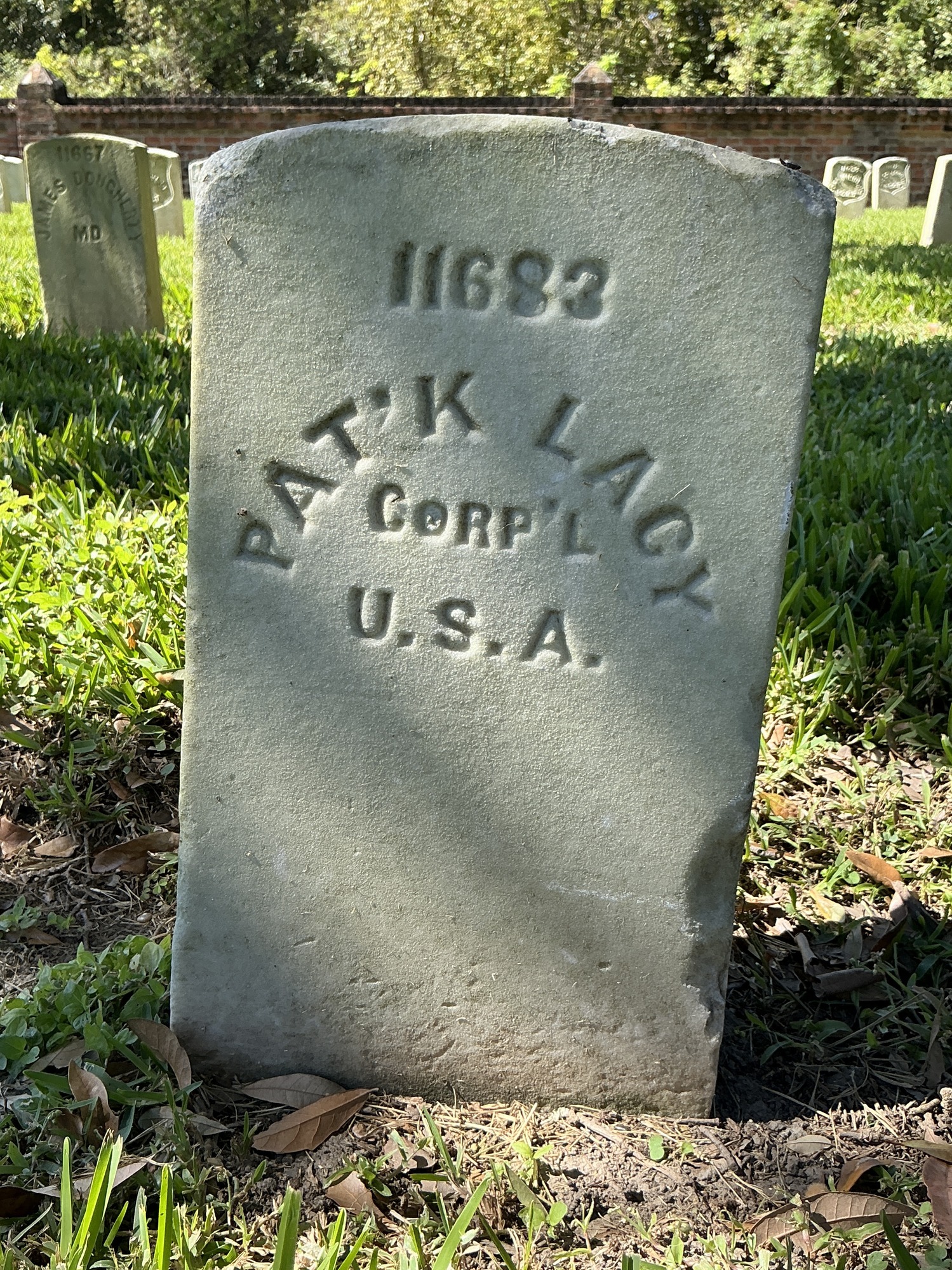 Front of historic upright marble headstone with flat face.