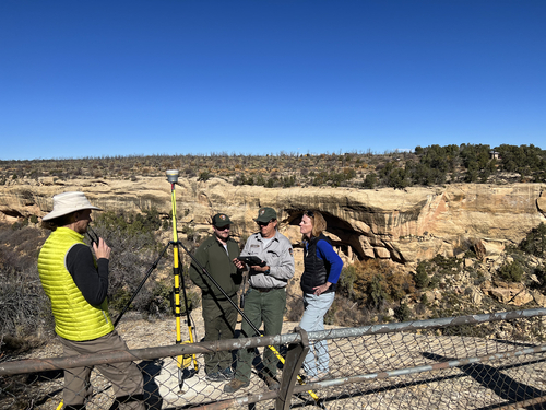 NPS workers consult on set up of GNSS geodetic control base station.