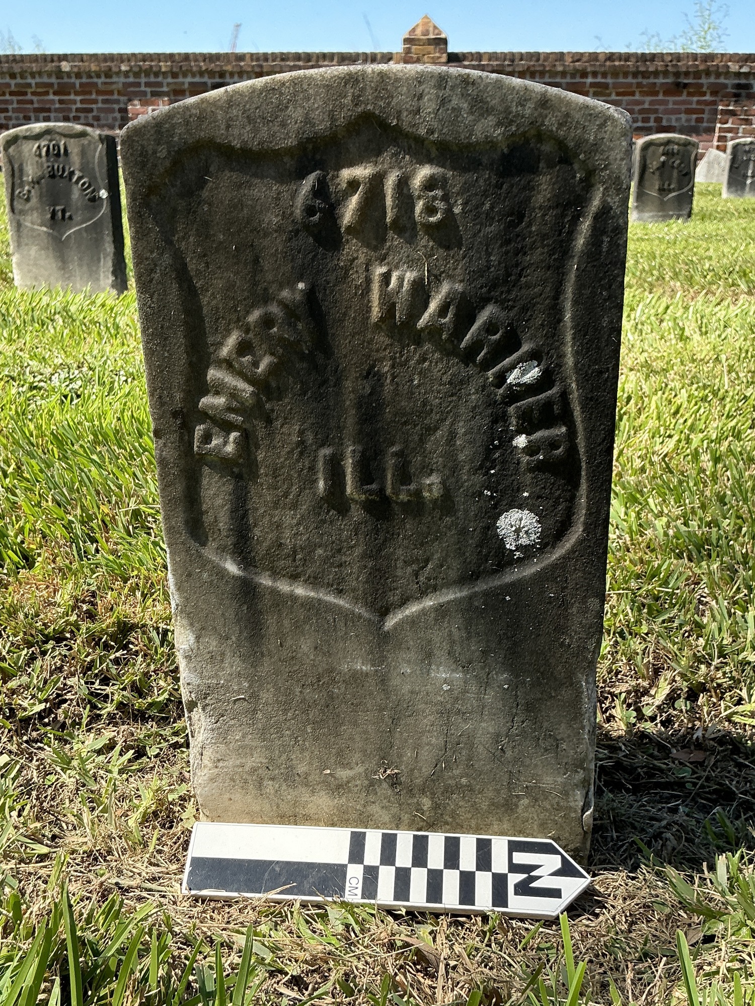 Extra image of historic upright marble headstone with recessed shield face.