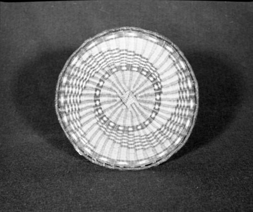 Marie Rozier Collection, Catalog No. 93. Object: Hopi wicker plaque. Dimensions: 9-3/4". Materials: Rabbit brush, dyes. Collection History: From Third Mesa. Acquired from Mary Long. Photographed by Michael Dixon in December 1982. Catalogued by Craig Bates and Barbara Beroza. Yosemite Collections, National Park Service.