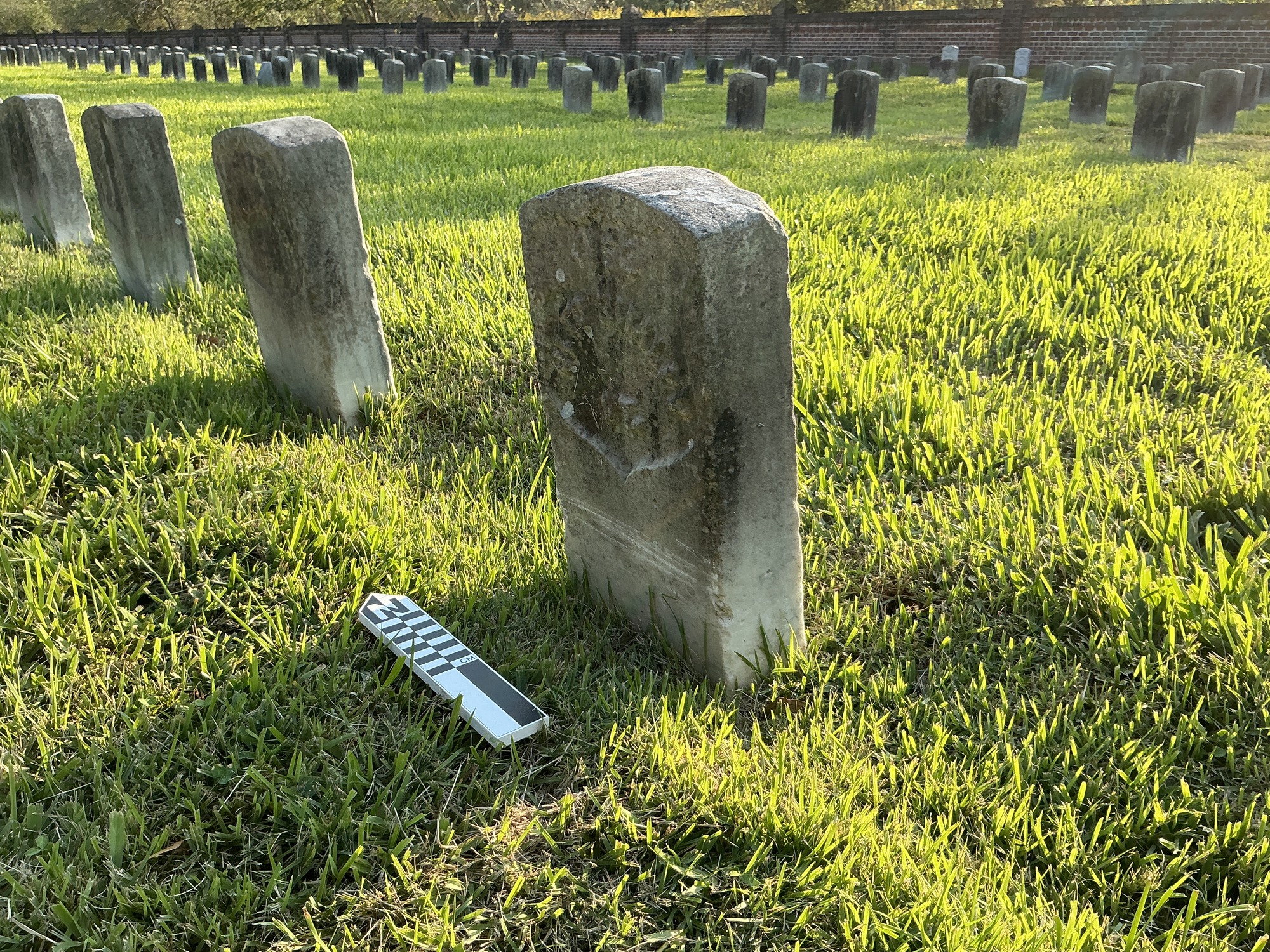 Extra image of historic upright marble headstone with recessed shield with recessed lettering face.