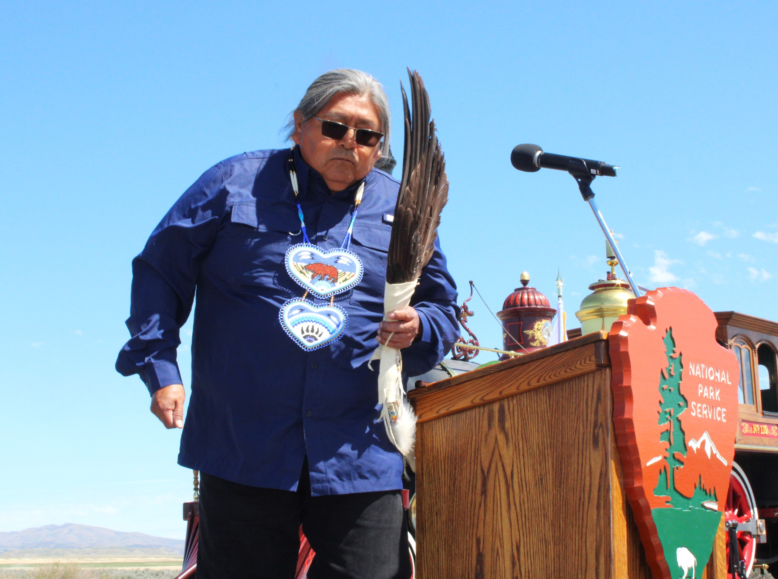 Native American Elder on stage with feathers in hand