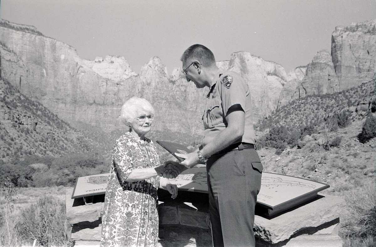 BW Photos of Superintendent Harold Grafe giving award to lady.