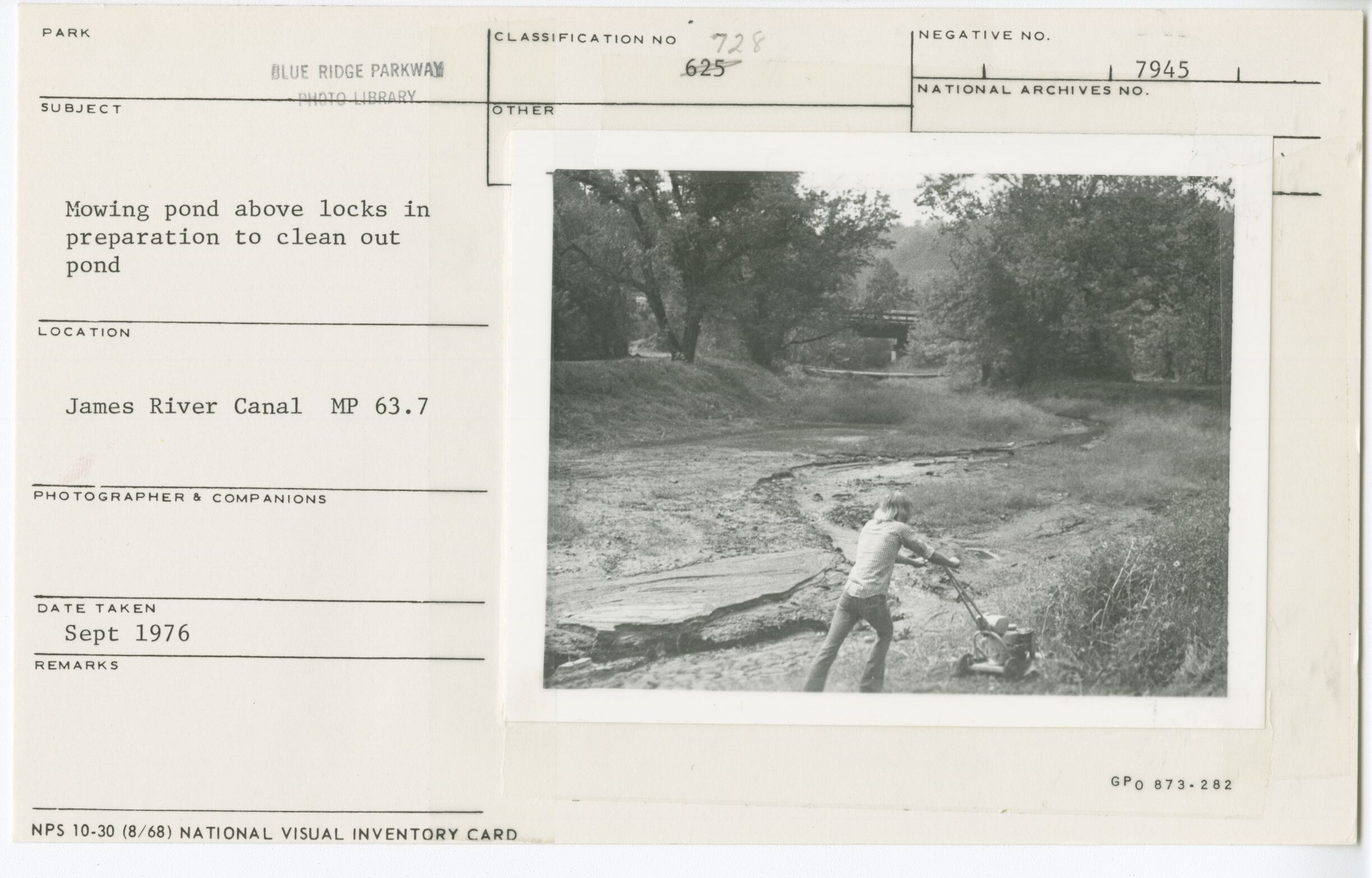 Mowing pond above locks in preparation to clean out pond