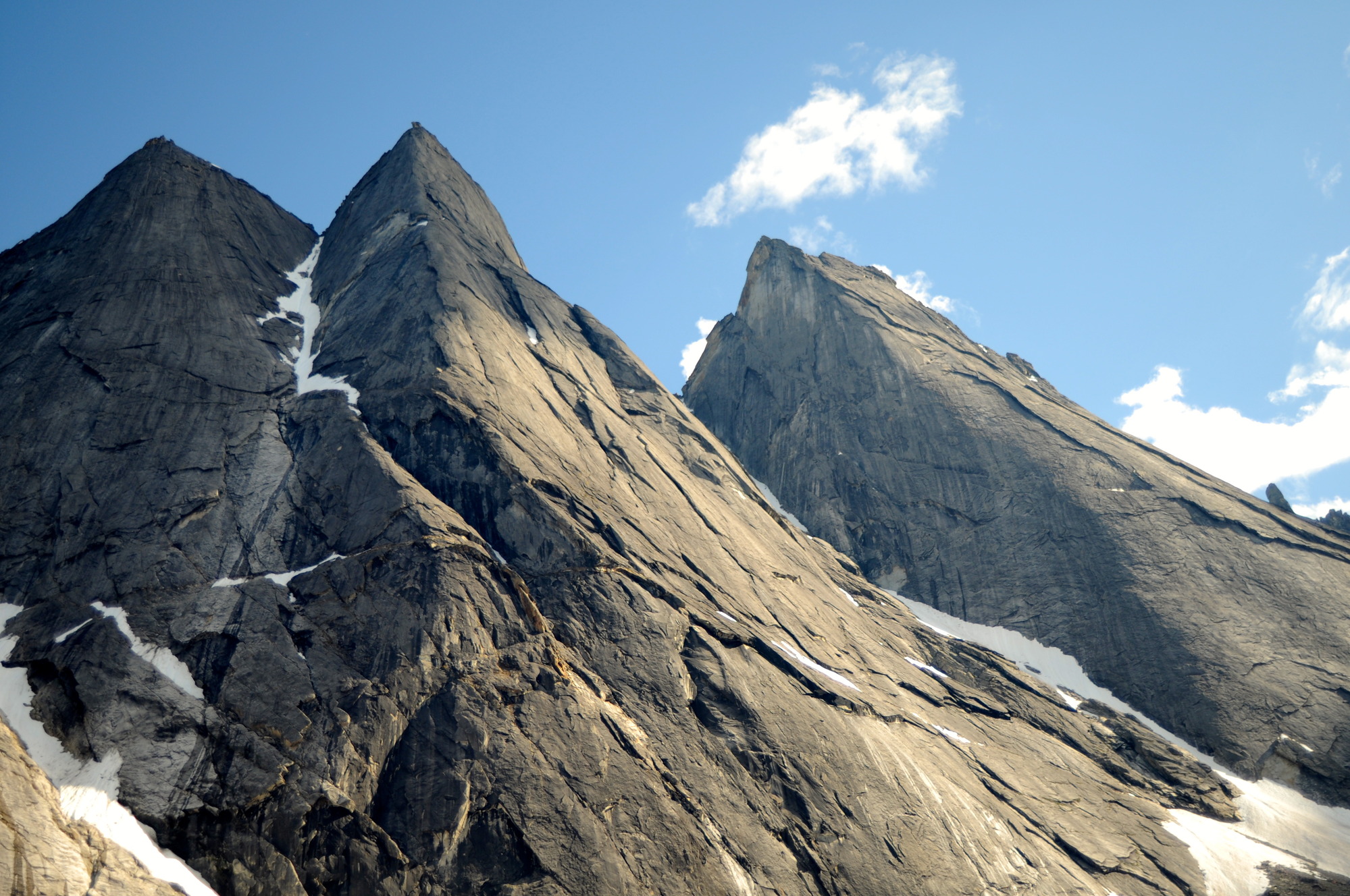 two sharp gray peaks under a blue sky.