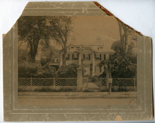 Black and white photograph of Georgian mansion with top left and right corners missing.