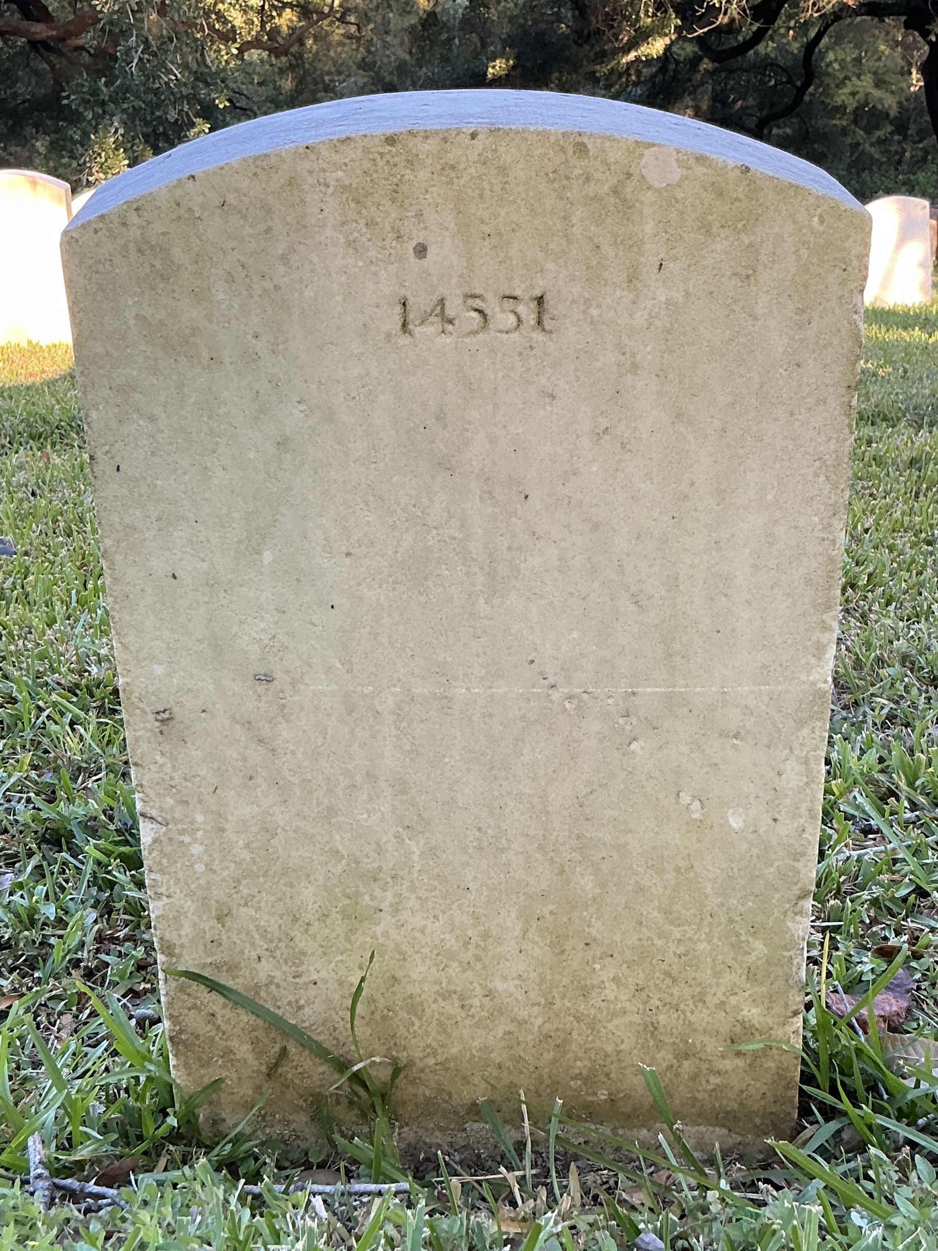 Back of upright marble headstone with flat face.