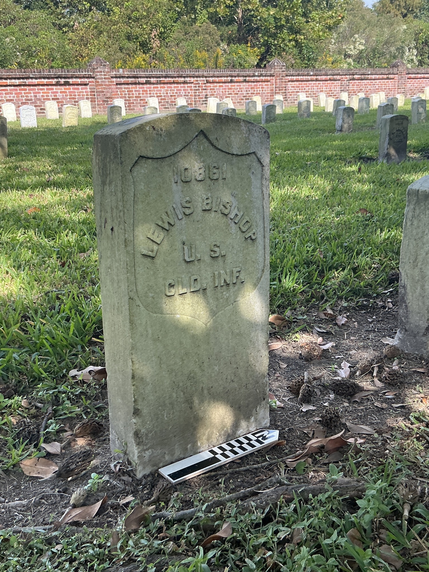 Extra image of historic upright marble headstone with recessed shield face.