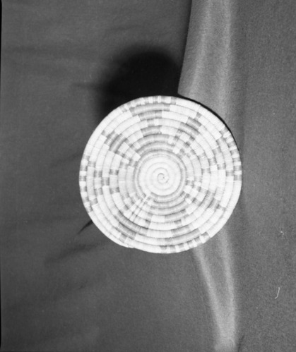 Marie Rozier Collection, Catalog No. 4. Object: Hopi coiled plaque. Dimensions: 11". Materials: Yucca, rabbit buckbrush, dyes. Technology: Leftward coil direction, interlocking stitch. Collection History: From Second Mesa. Acquired from G. DuGay. Photographed by Michael Dixon in December 1982. Catalogued by Craig Bates and Barbara Beroza. Yosemite Collections, National Park Service.