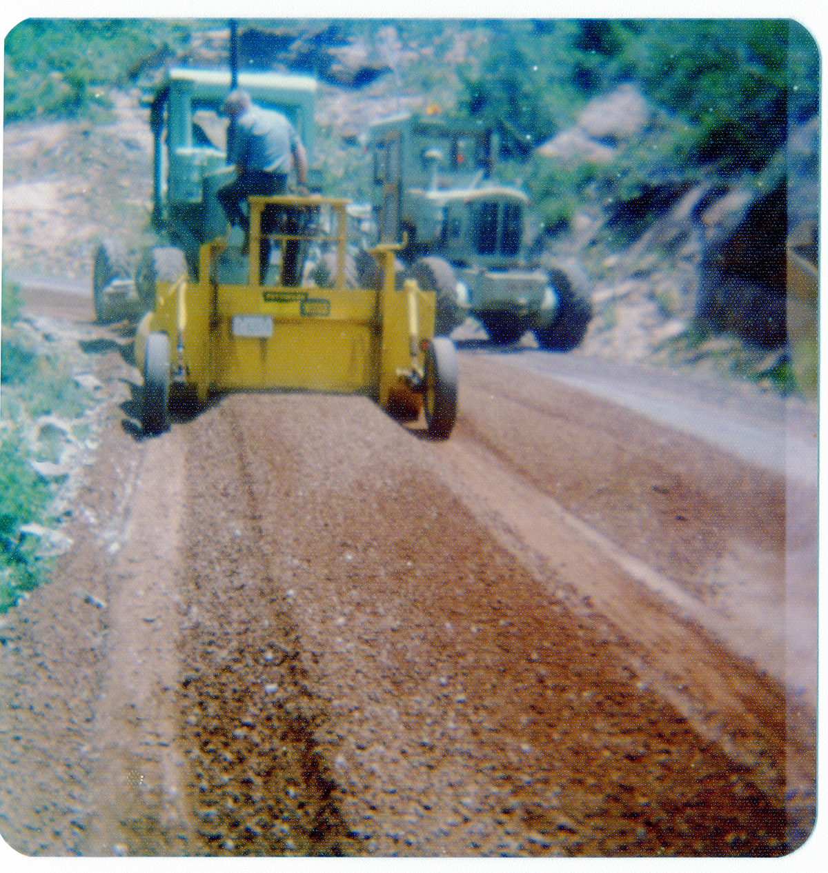 Construction vehicles performing road work along the Kolob Terrace Road.