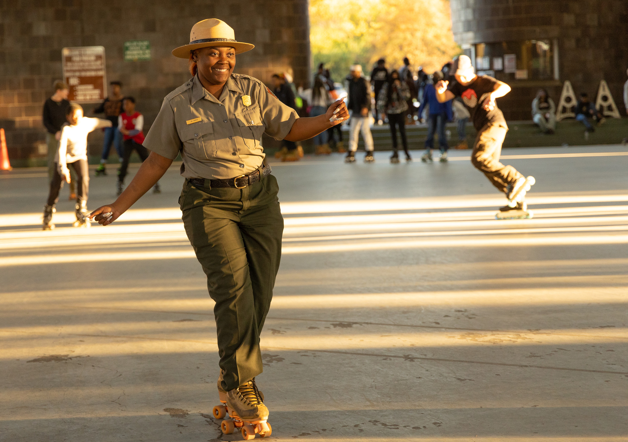 A park ranger skates around a skating rink.