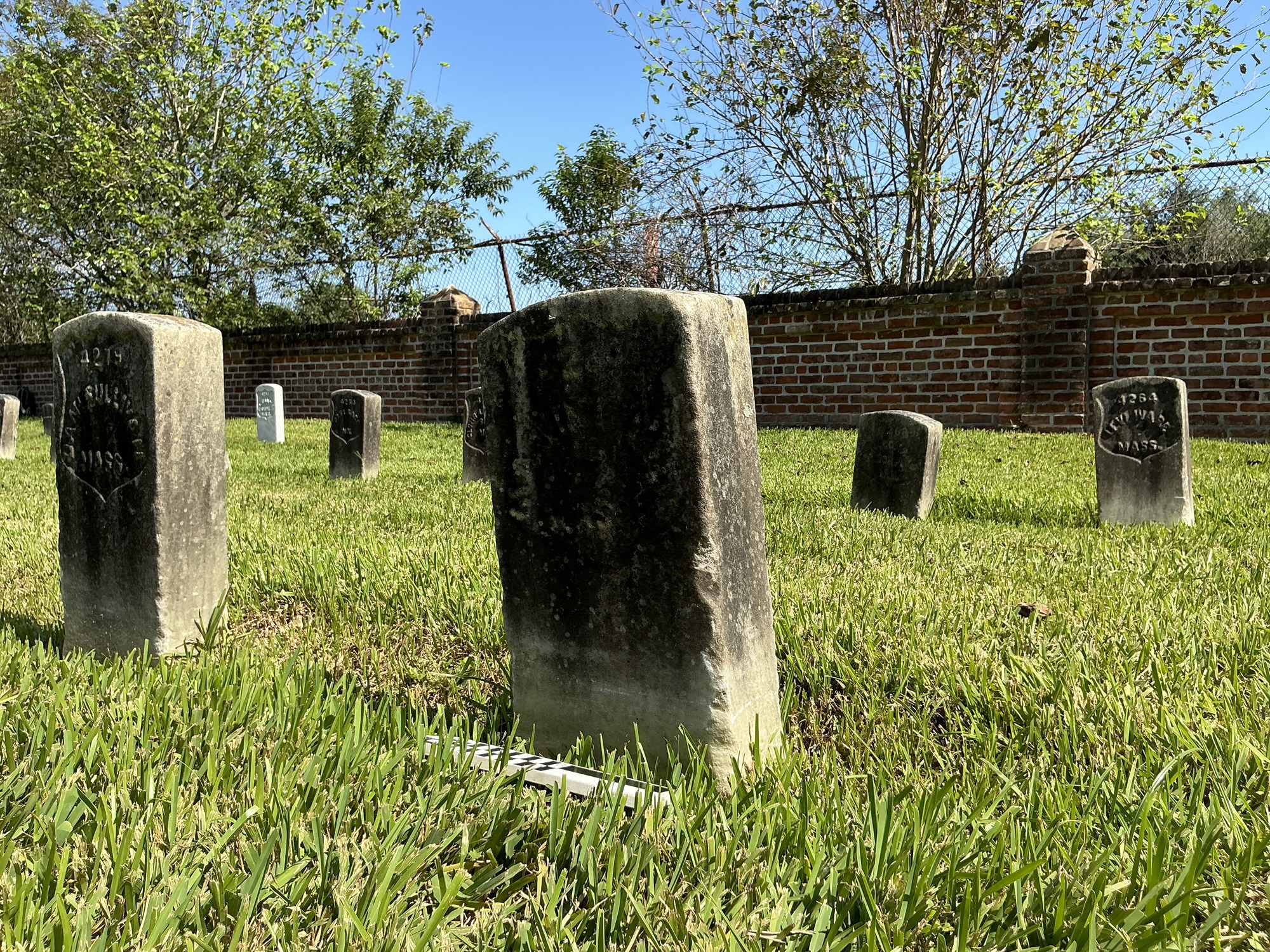 Extra image of historic upright marble headstone with recessed shield face.